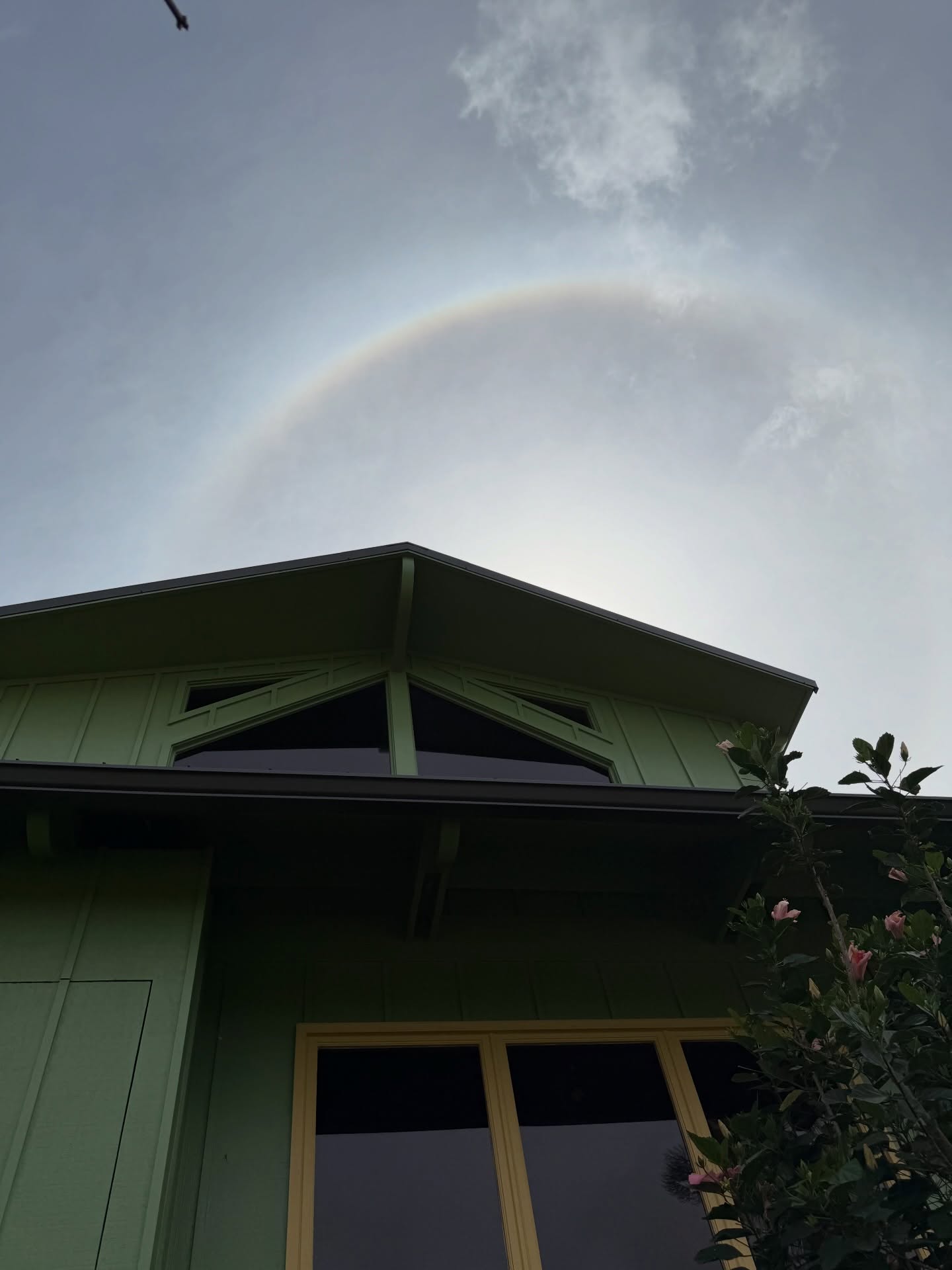 A halo of light above the green gable of Cosmic Campus